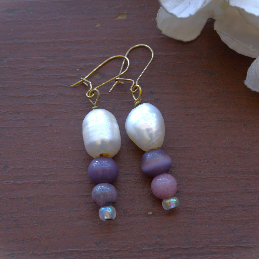 Pearl and bead earrings on a wooden surface