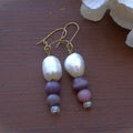 Pearl and bead earrings on a wooden surface